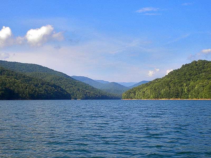 clear mountain and lake waters from a pontoon boat on Fontana Lake in Bryson City NC